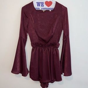 Red romper with ruffles around the waist